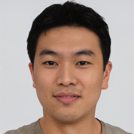 Joyful asian young-adult male with short  black hair and brown eyes