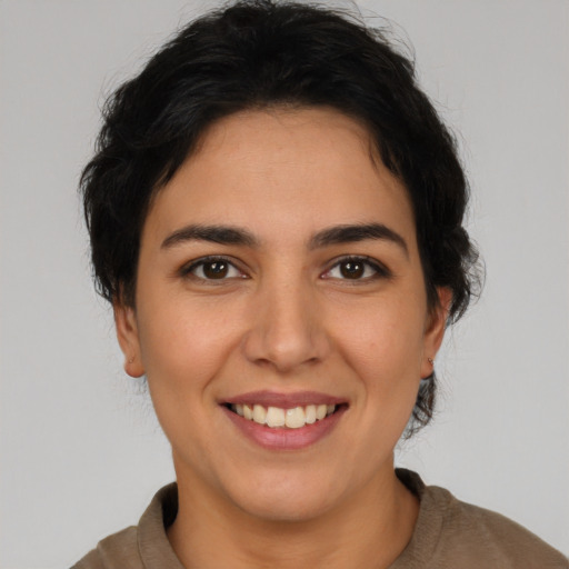 Joyful latino young-adult female with short  brown hair and brown eyes