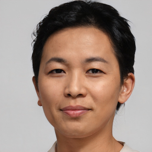 Joyful asian adult female with short  black hair and brown eyes