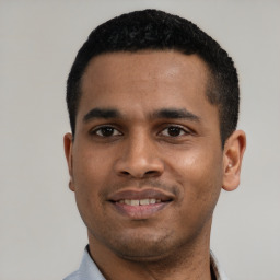 Joyful black young-adult male with short  black hair and brown eyes