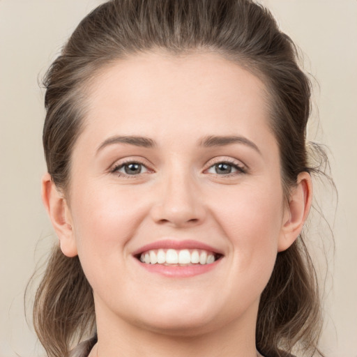 Joyful white young-adult female with long  brown hair and grey eyes