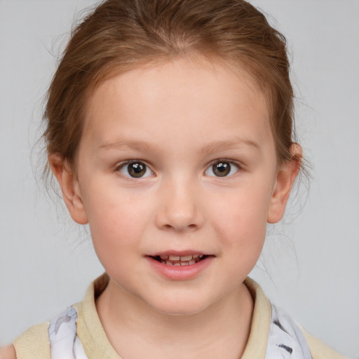 Joyful white child female with medium  brown hair and brown eyes