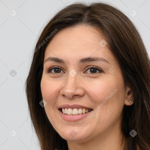 Joyful white young-adult female with long  brown hair and brown eyes