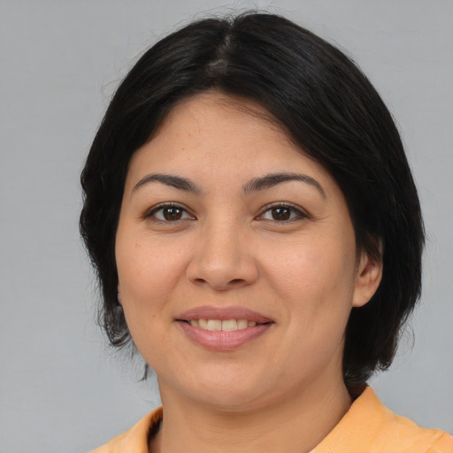 Joyful asian young-adult female with medium  brown hair and brown eyes