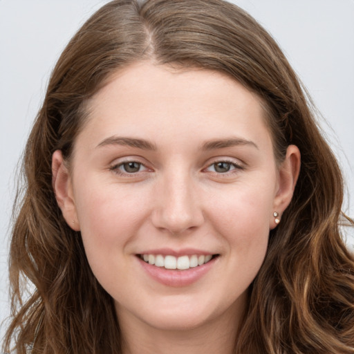 Joyful white young-adult female with long  brown hair and grey eyes