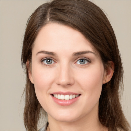 Joyful white young-adult female with medium  brown hair and green eyes