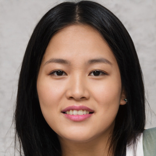 Joyful asian young-adult female with long  black hair and brown eyes