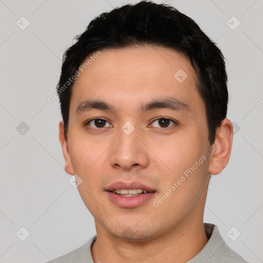 Joyful white young-adult male with short  black hair and brown eyes