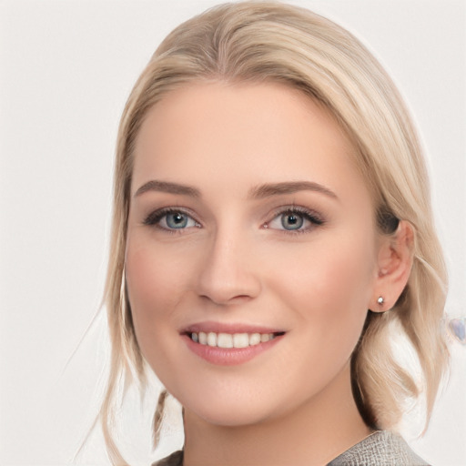 Joyful white young-adult female with medium  brown hair and blue eyes