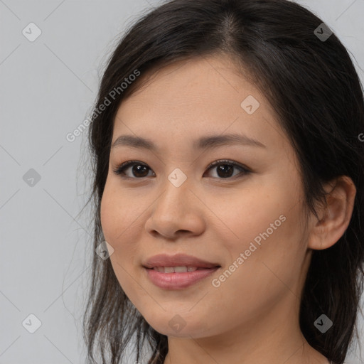 Joyful asian young-adult female with long  brown hair and brown eyes