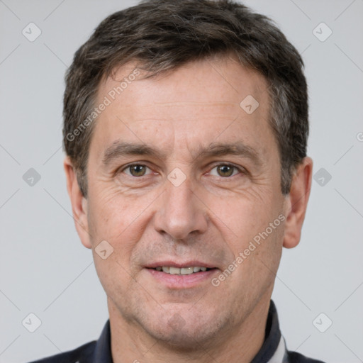 Joyful white adult male with short  brown hair and brown eyes