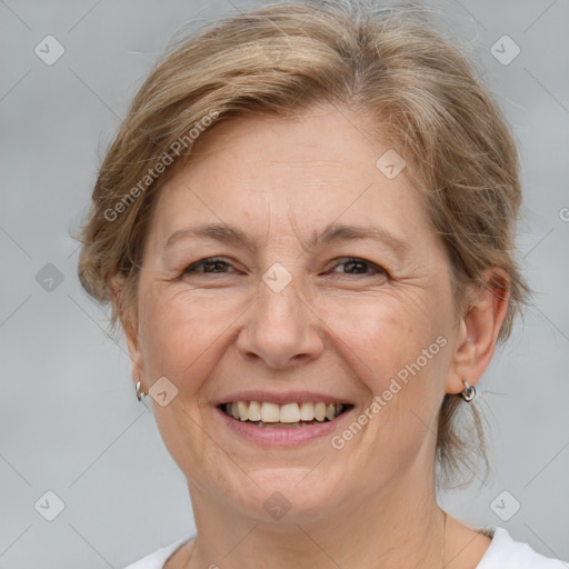 Joyful white adult female with medium  brown hair and grey eyes