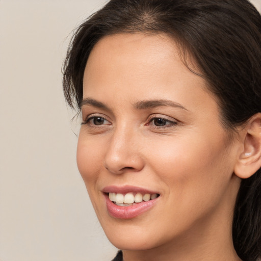 Joyful white young-adult female with long  brown hair and brown eyes