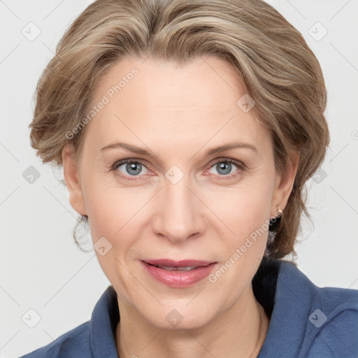 Joyful white adult female with medium  brown hair and blue eyes