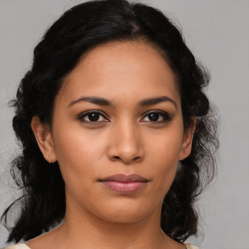 Joyful latino young-adult female with medium  brown hair and brown eyes