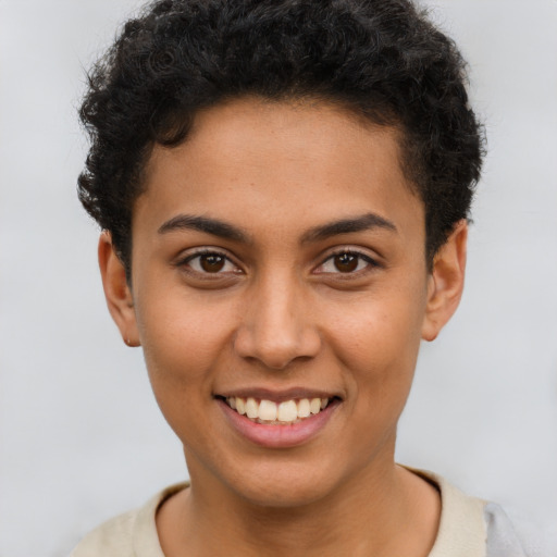 Joyful latino young-adult female with short  brown hair and brown eyes