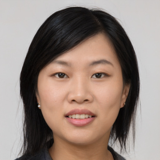 Joyful asian young-adult female with medium  black hair and brown eyes