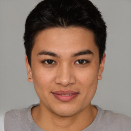 Joyful latino young-adult male with short  brown hair and brown eyes