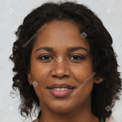 Joyful black young-adult female with long  brown hair and brown eyes