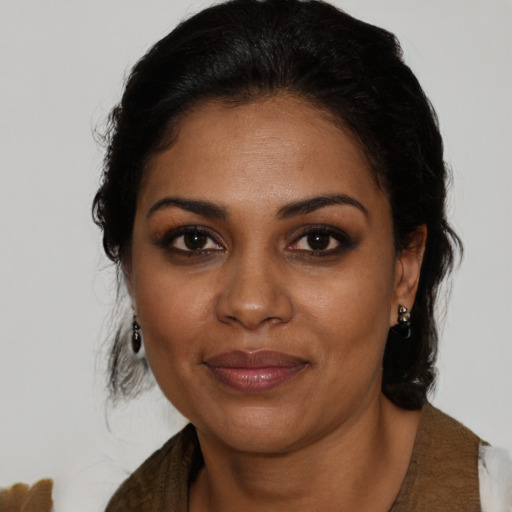 Joyful black young-adult female with medium  brown hair and brown eyes
