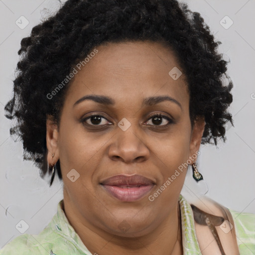 Joyful black adult female with short  brown hair and brown eyes