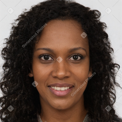 Joyful black young-adult female with long  brown hair and brown eyes