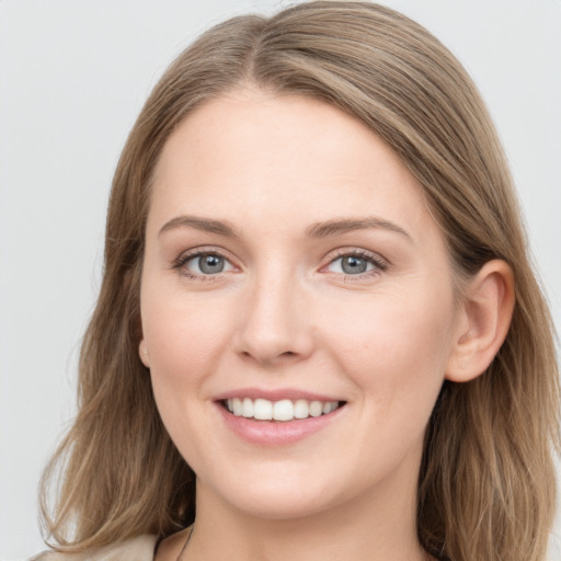 Joyful white young-adult female with long  brown hair and grey eyes