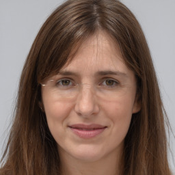 Joyful white adult female with long  brown hair and brown eyes