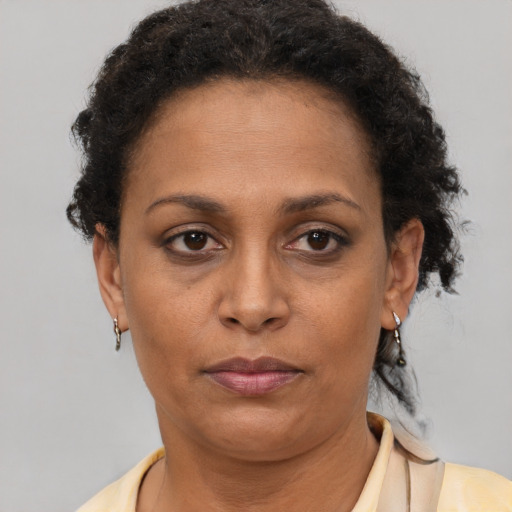 Neutral black adult female with short  brown hair and brown eyes