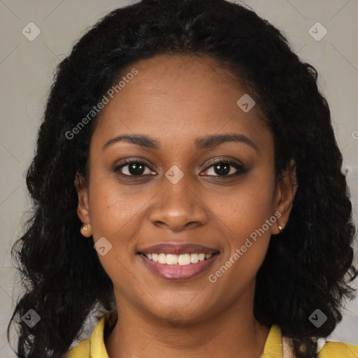 Joyful black young-adult female with long  brown hair and brown eyes