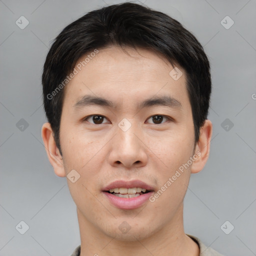 Joyful asian young-adult male with short  brown hair and brown eyes