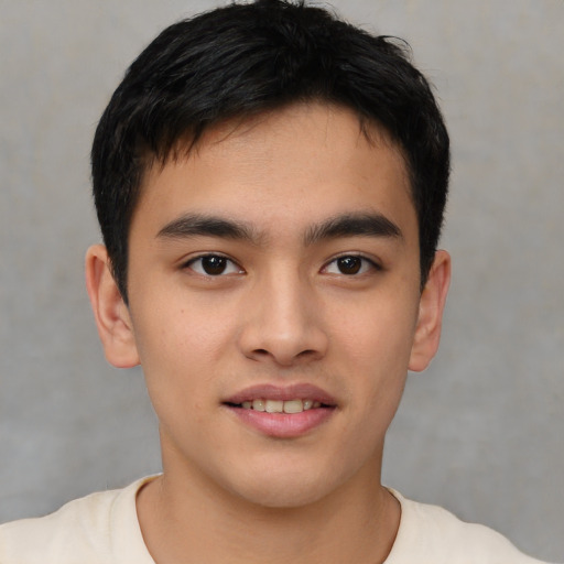 Joyful asian young-adult male with short  brown hair and brown eyes