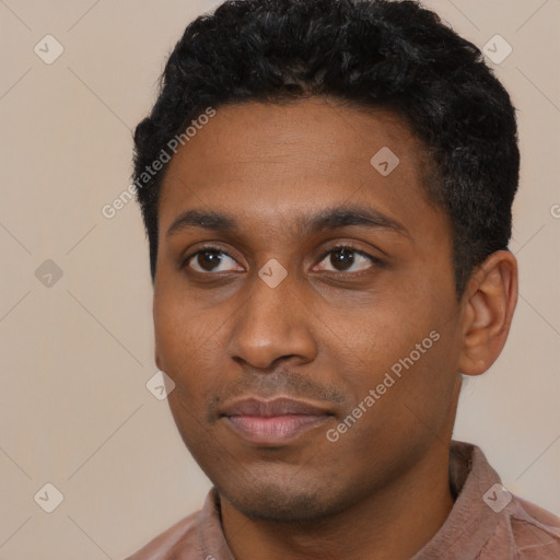 Joyful black young-adult male with short  black hair and brown eyes