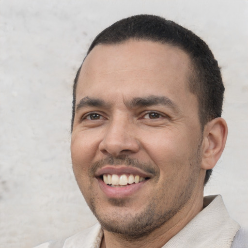 Joyful white adult male with short  black hair and brown eyes