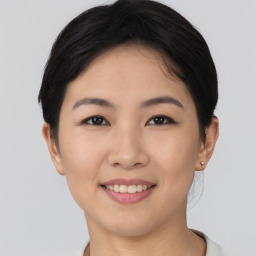 Joyful asian young-adult female with short  black hair and brown eyes