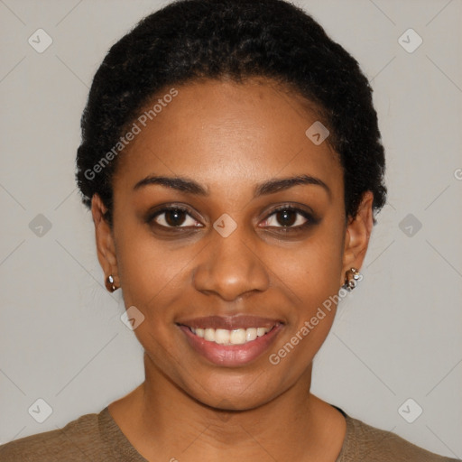 Joyful black young-adult female with short  black hair and brown eyes