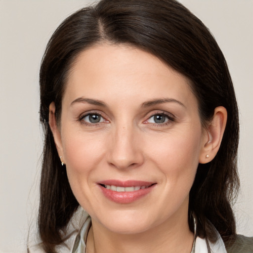 Joyful white adult female with medium  brown hair and brown eyes