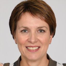 Joyful white adult female with medium  brown hair and grey eyes