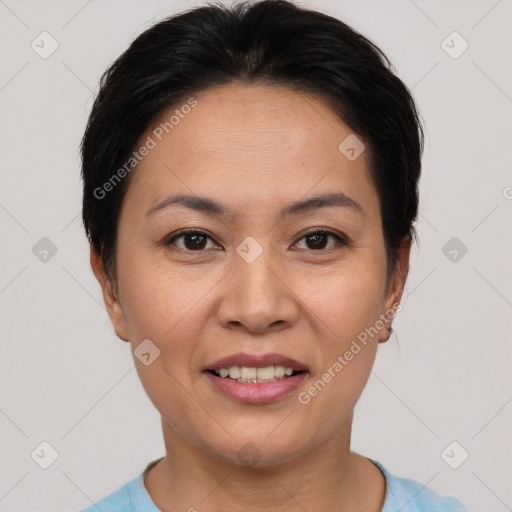 Joyful asian adult female with short  black hair and brown eyes