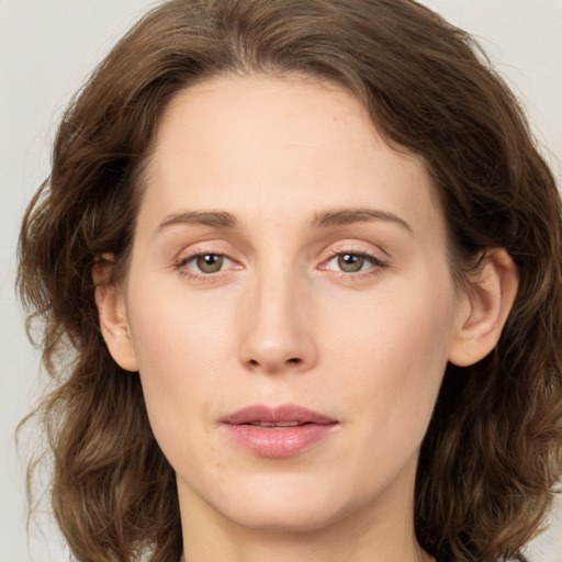 Joyful white young-adult female with medium  brown hair and green eyes