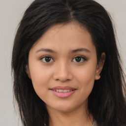 Joyful asian young-adult female with long  brown hair and brown eyes