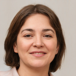 Joyful white young-adult female with medium  brown hair and brown eyes