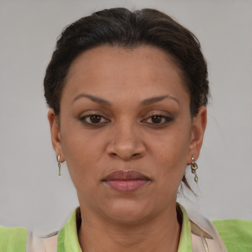 Joyful latino adult female with short  brown hair and brown eyes