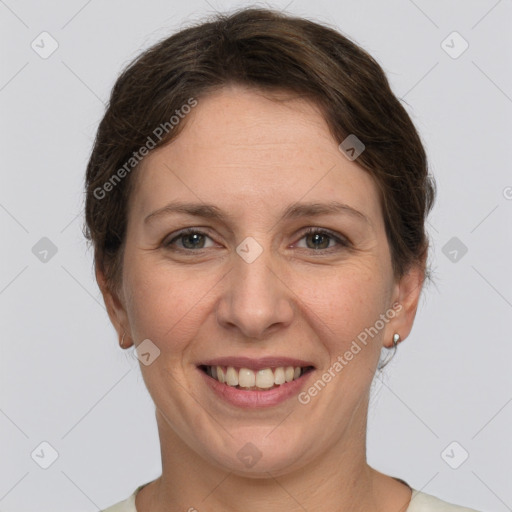 Joyful white adult female with short  brown hair and grey eyes