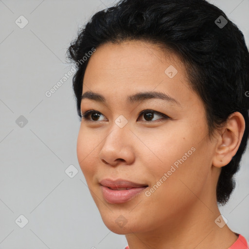 Joyful asian young-adult female with short  black hair and brown eyes