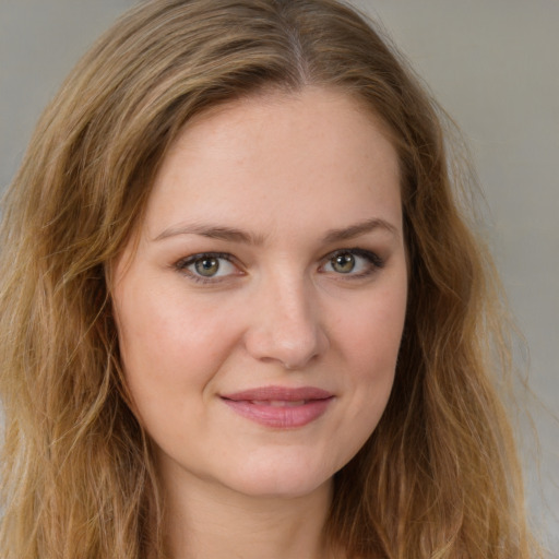 Joyful white young-adult female with long  brown hair and green eyes