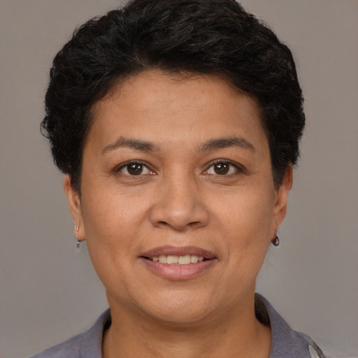 Joyful white adult female with short  black hair and brown eyes