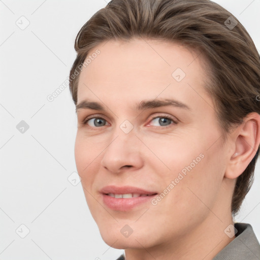 Joyful white young-adult female with medium  brown hair and grey eyes