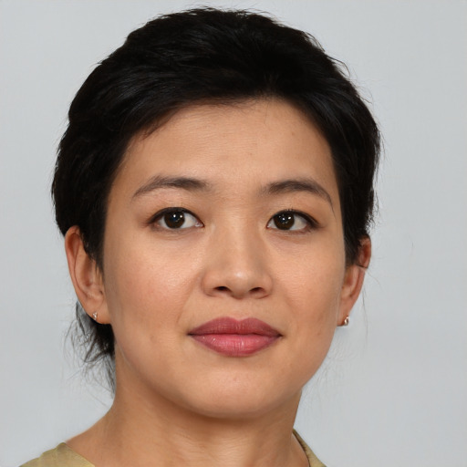 Joyful asian young-adult female with medium  brown hair and brown eyes