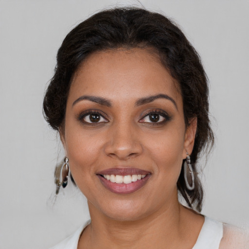 Joyful latino young-adult female with medium  brown hair and brown eyes